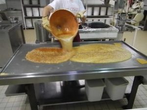 Spreading and downcooling the sugar on a table. CDHV.