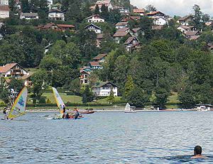 Surfers and swimmer at Lake Gerardmer.